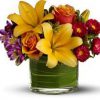 lilies, roses, alstroemeria, leaf-lined vase, fresh greenery, peach, orange, purple, red